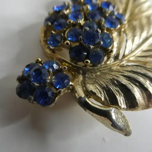 Vintage Flower Leaf Brooch Cluster Pin Blue Rhinestone Jeweled Gold Tone Retro