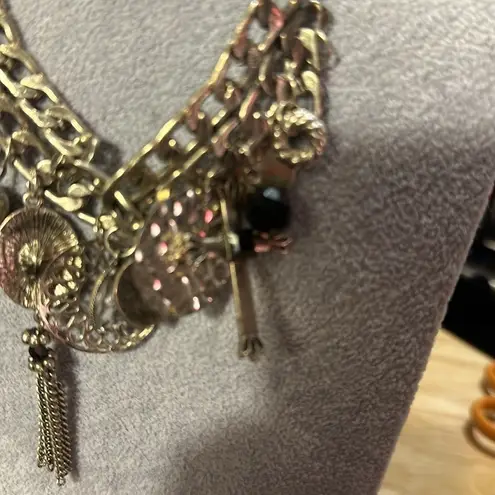 Very cute charm necklace. It has a cross with black in the middle.