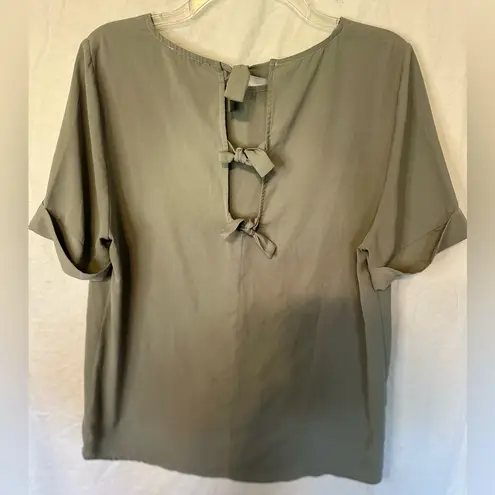 Staccato green blouse with tie back closure. Size large