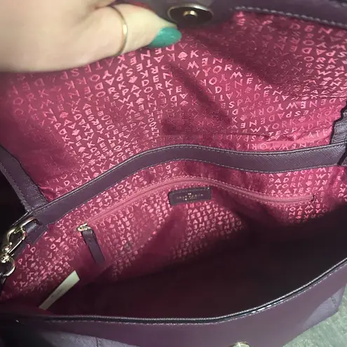 Kate Spade  Laurel Way Lilah satchel in a burgundy or mulberry color.