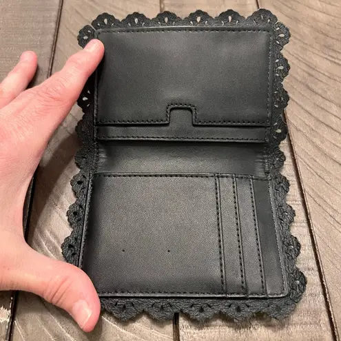 Kate Spade  NWOT NY Lacy mini wallet. Black leather with gold lettering.