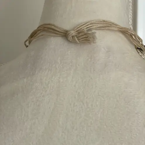 Woven medallion cord beach necklace with wooden beads accents sea horse pendant.