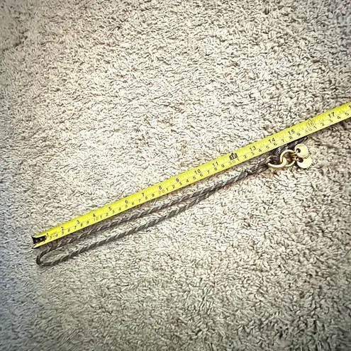 Gold tone pendant necklace on cord