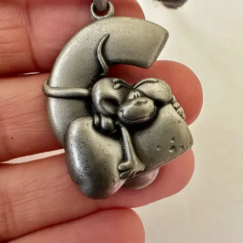 Silver tone cartoon dog on C pendant necklace on cord