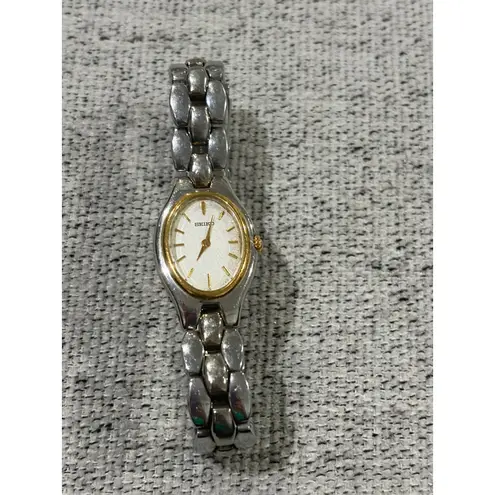 Seiko Oval Women's Two Tone Silver and Gold Wrist Sunburst Dial Watch 1N00-6F80