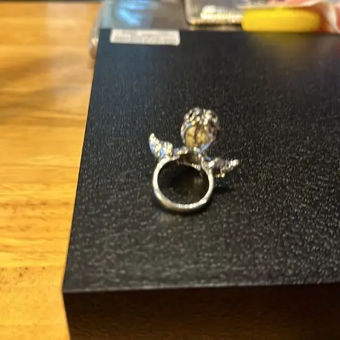 Beautiful ring it has a red colored heart stone in the middle. Size 6 angel.