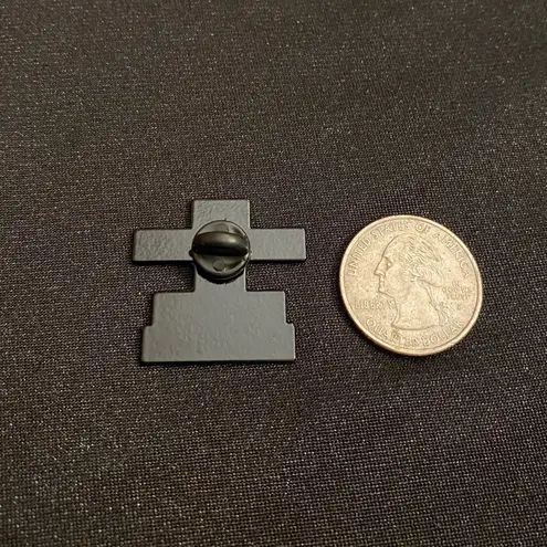 Enamel pin/magnet starts off nicely enough, but takes a sharp turn Black