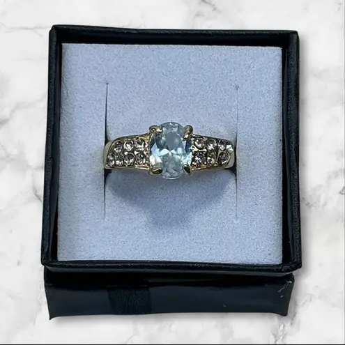 Gold Tone Ring With Oval Cut Light Blue Center Stone & Accent Crystals Size 7