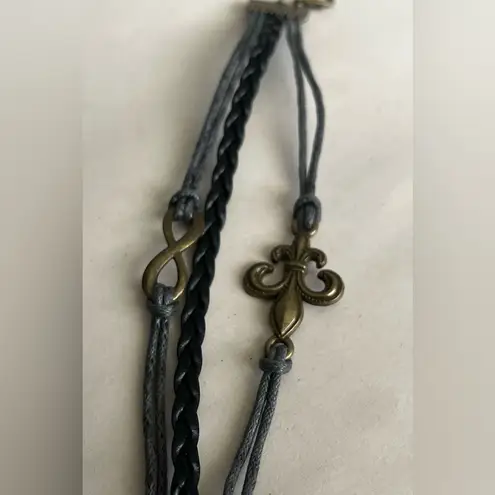 Fleur De Lis and infinity wax coated leather and cord bracelet