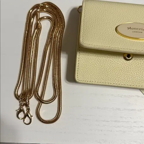 Moncrief London Italian leather wallet in a light color cream or yellow.