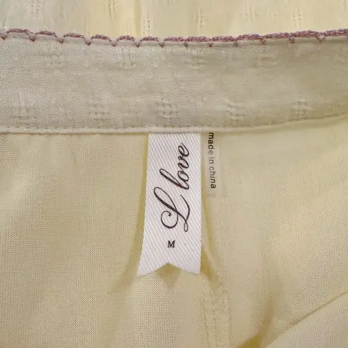 L LOVE Light Yellow Peplum Blouse with Vibrant Braided Pom Pom Tassels