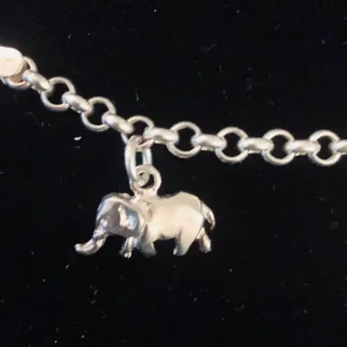 Sterling silver and peridot lucky charm bracelet.