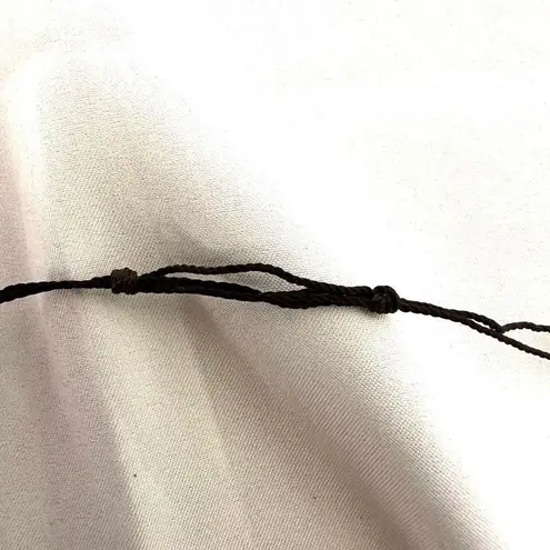 Silver tone horn pendant necklace on brown cord