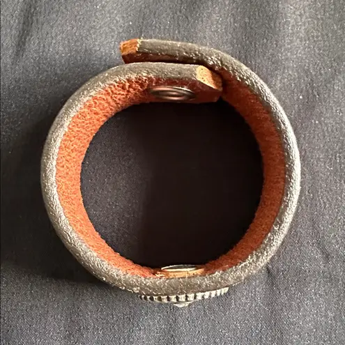 Leather EUC snap bracelet with silvertone medallion and CZ center stone Brown