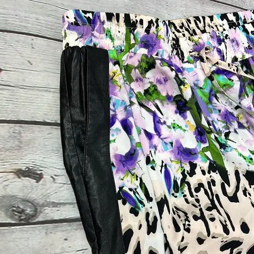 Bebe  Floral Animal print blend joggers with faux leather side pockets. Size M