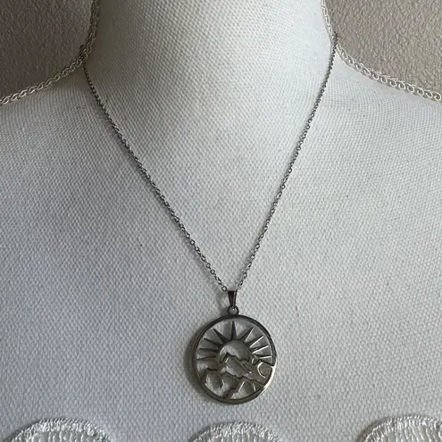 Sun mountain open work silvertone necklace