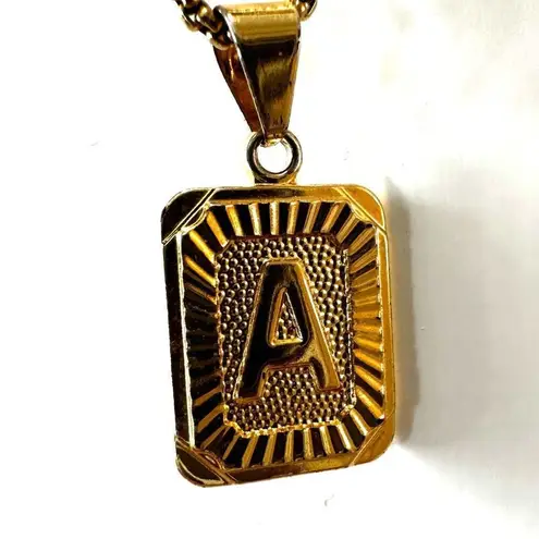 Gold tone A monogram pendant necklace