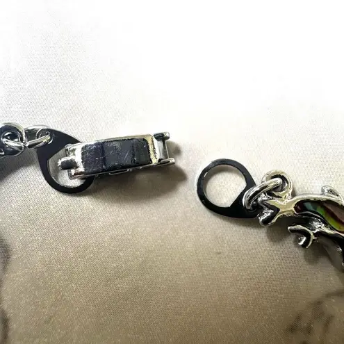 Silver tone dolphin pink abalone bracelet