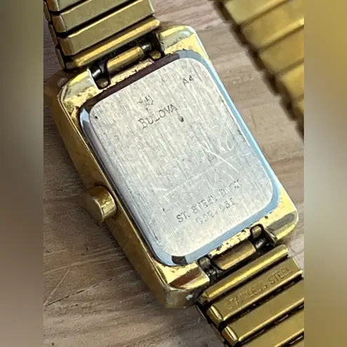 Caravelle by Bulova Ladies Watch Crystals White Dial Gold Tone Stretch Bracelet