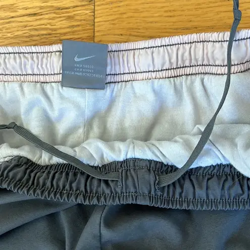 Nike 𝅺 grey pink and white lined track pants size L (12-14)