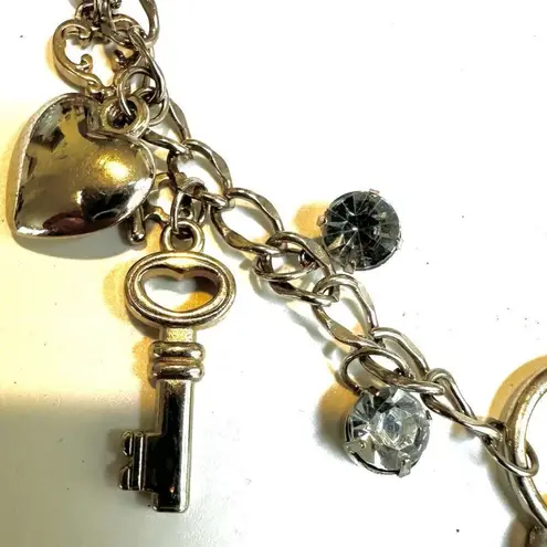 Silver tone heart and key long charm necklace