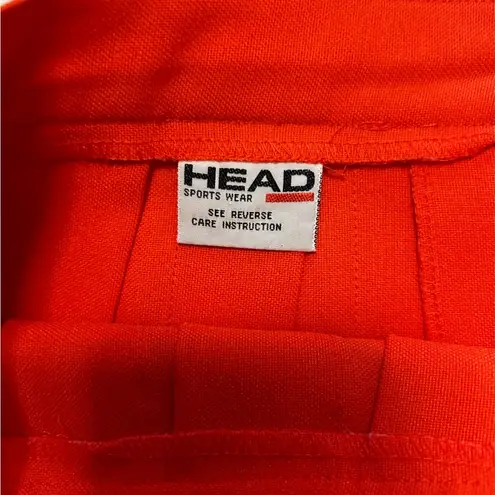 Head  orange pleated tennis skirt