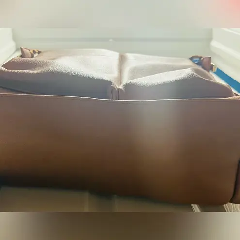 Brown patent leather diaper bag with multiple pockets and key holders