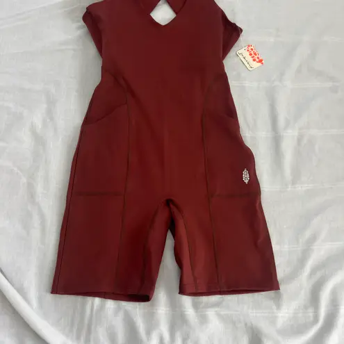 Free People Movement Here On Out Strappy Onesie Romper   Size XS  Condition: NWT  Color: nutmeg  Details : - See photo for approx. inseam measurement laying flat  - Built-in bra - not padded - Side pockets.