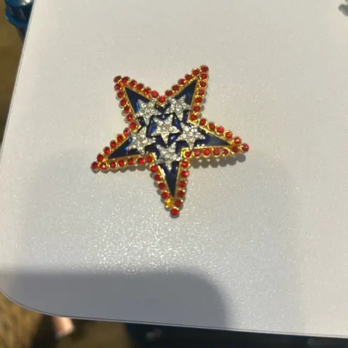 Beautiful pin Star. Red, white and blue there is a signature in the back.
