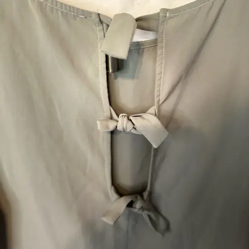 Staccato green blouse with tie back closure. Size large