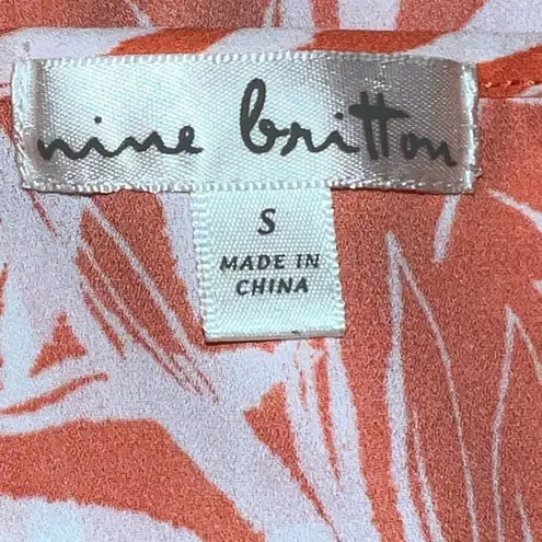 Nine Britton  cute new white tie front top with orange floral design.