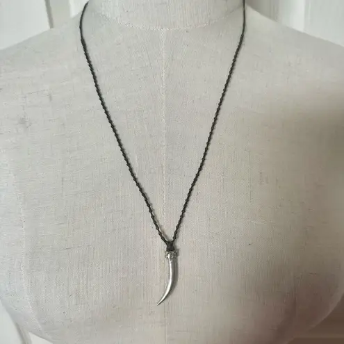 Silver tone horn pendant necklace on brown cord