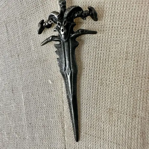 Silver tone sword necklace Gray