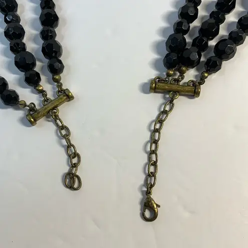 Vintage style 3 strand black beaded necklace with gold tone feather accent