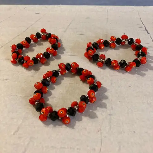 Source Unknown Pile of Red & Black Plastic Stretch Bracelets Louisville/Cal State/Grinnell