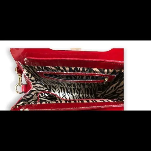 Zebra style print with red and gold accents shoulder tote purse. Patent leather Black