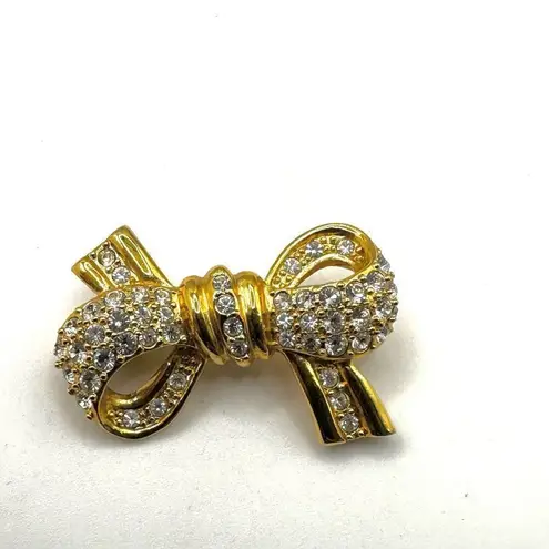 Roman gold tone rhinestone bow brooch