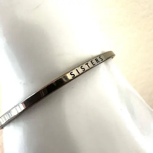 Silver tone sisters bangle bracelet