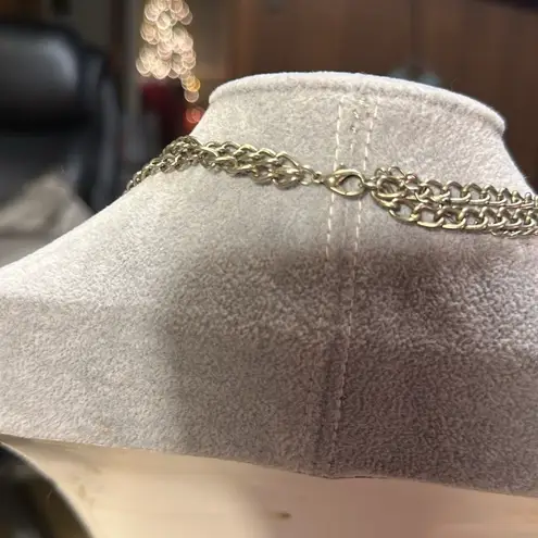 Very cute charm necklace. It has a cross with black in the middle.