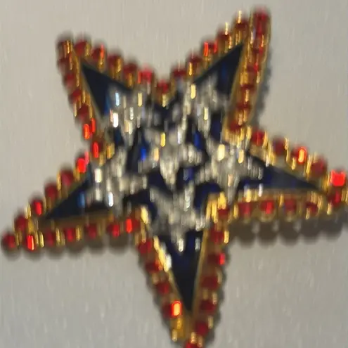 Beautiful pin Star. Red, white and blue there is a signature in the back.