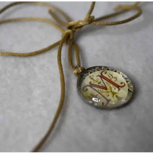 Source Unknown Cottagecore Monogram Resin Encased "M" Gold Tone Silk Cord Pendant Necklace