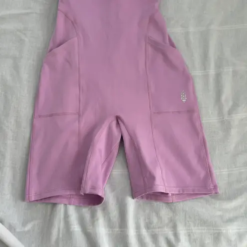 Free People Movement Here On Out Strappy Onesie Romper   Size XS  Condition: NWT  Color: bright orchid   Details : - See photo for approx. inseam measurement laying flat  - Built-in bra - not padded - Side pockets.