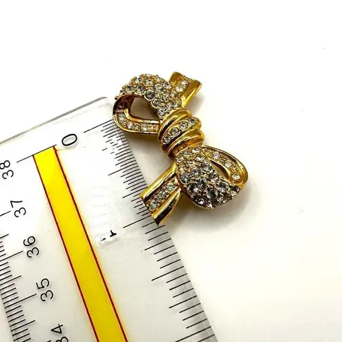 Roman gold tone rhinestone bow brooch