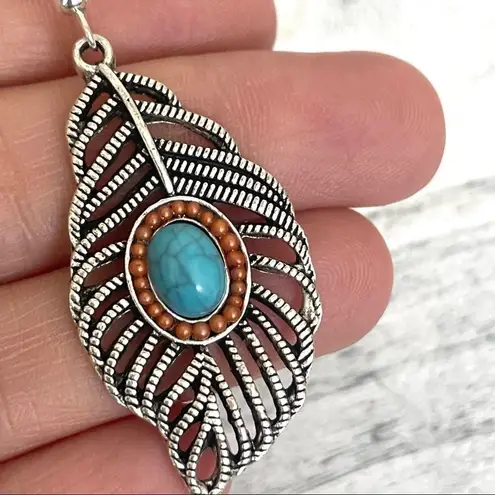 Silver tone feather and faux turquoise earrings