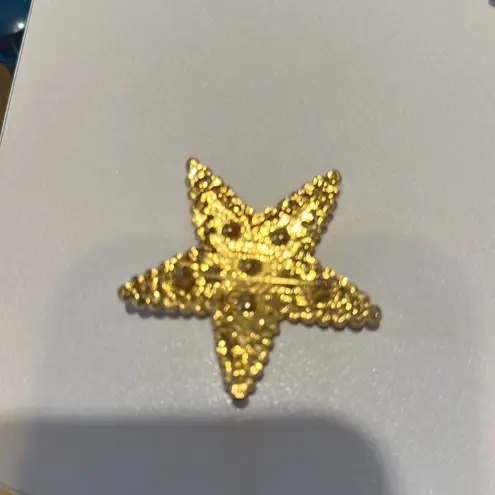 Beautiful pin Star. Red, white and blue there is a signature in the back.