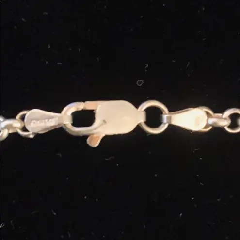 Sterling silver and peridot lucky charm bracelet.