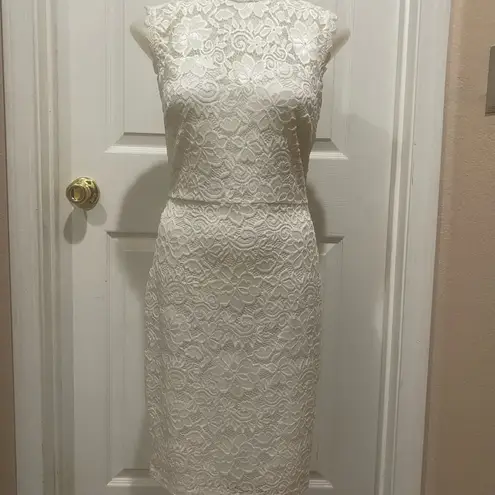 Mystic White lace dress with open back.