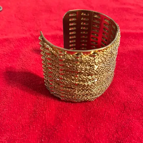 Intricate Gold Cuff Bracelet with Textured Surface and Decorative Element