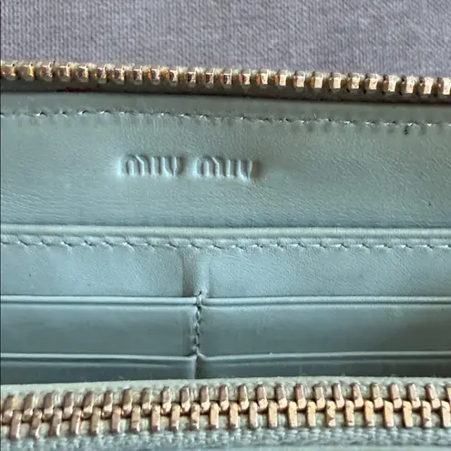 Miu Miu Metallic Gold Croc-Embossed Wallet with light blue interior.