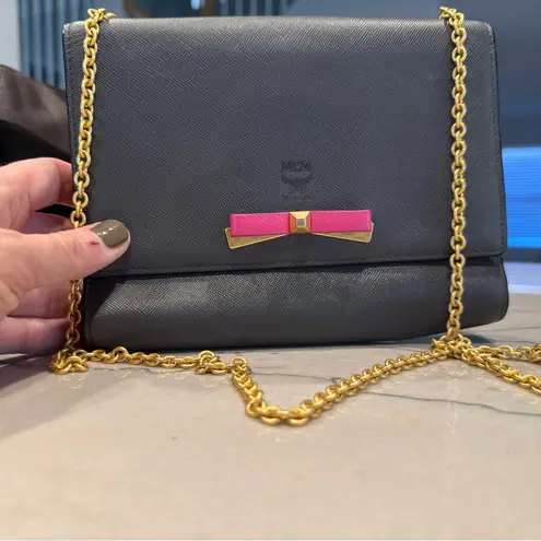 MCM Visetos Mina Crossbody Bag Dark Grey with a Pink Bow Accent
